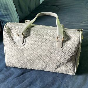 Light grey basket weave handbag with double handles.